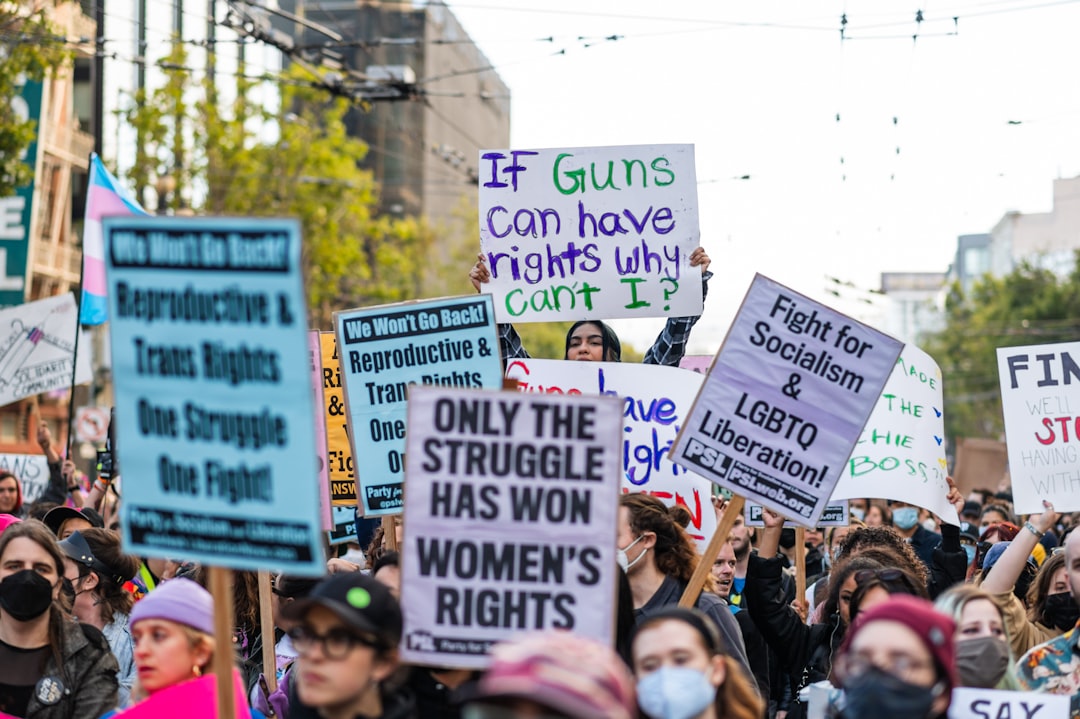 a-group-of-people-holding-signs-xqka5btnoso